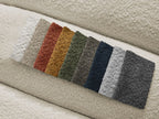Canapé d'angle fixe TALIA tissu bouclette avec pouf